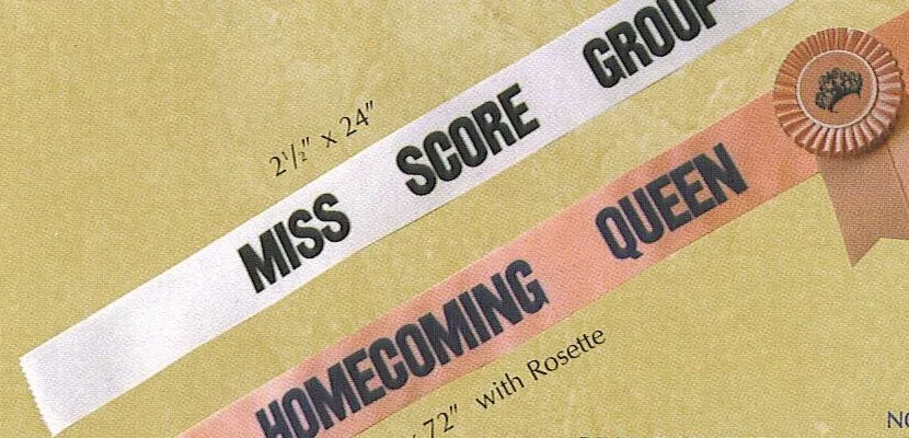 White and peach printed sashes reading Miss Score Group and Homecoming Queen